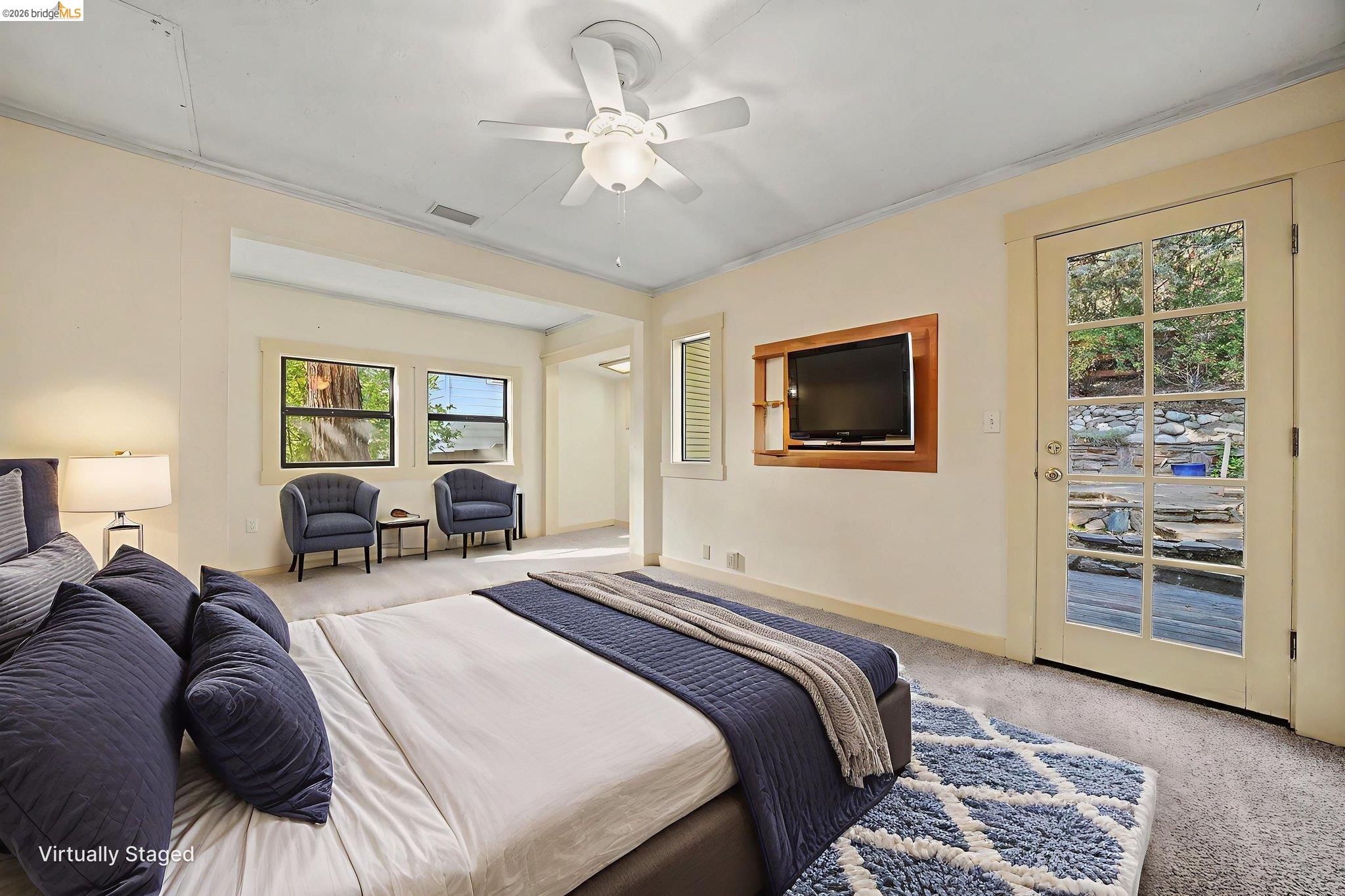 731 Dam Road Murphys, CA 95247 - Photo 24 of 60 a spacious bedroom with a bed a dresser and a chandelier