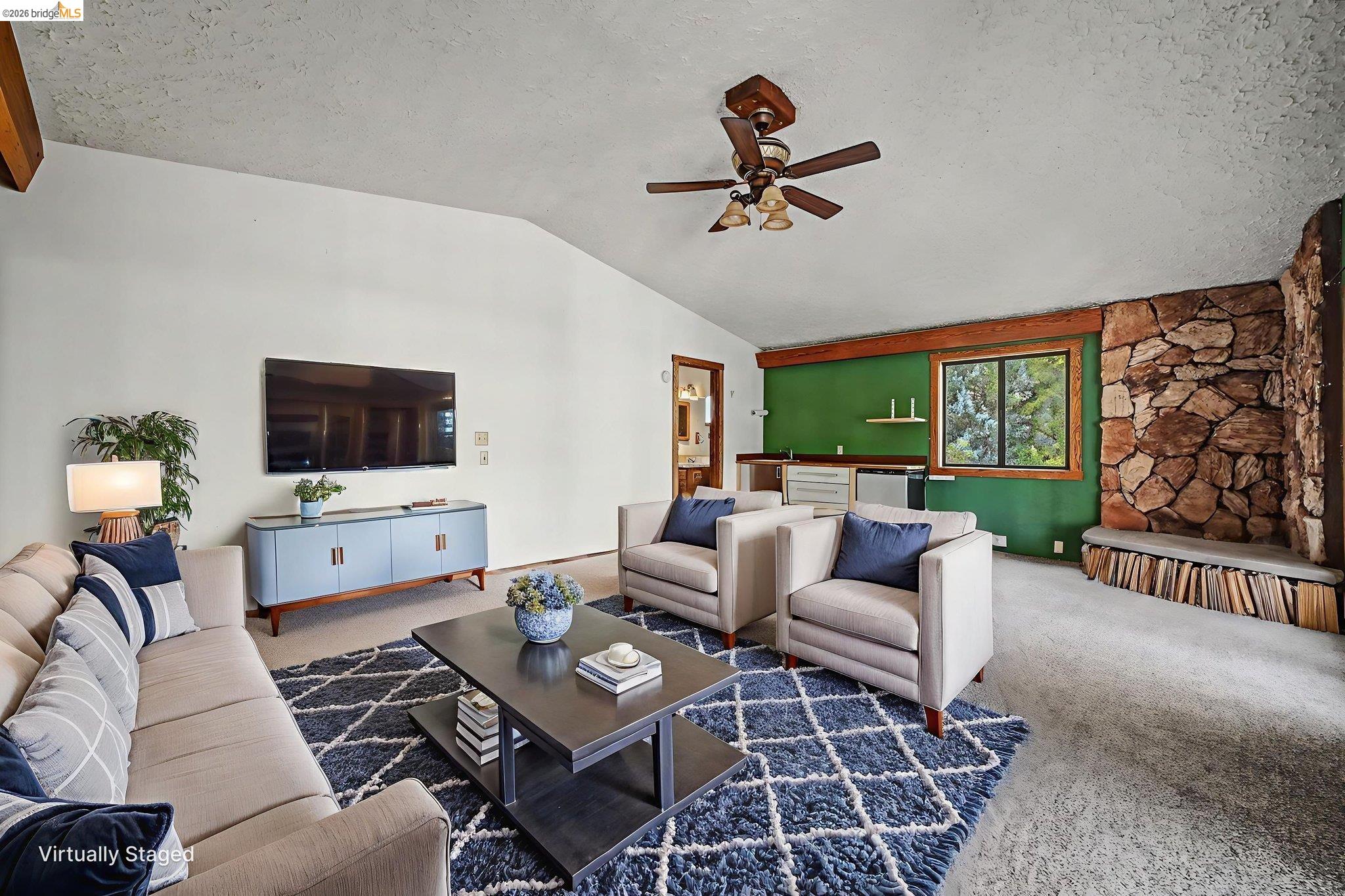 731 Dam Road Murphys, CA 95247 - Photo 36 of 60 a living room with furniture a flat screen tv and a floor to ceiling window
