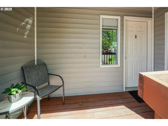 a view of wooden door and chair in wooden floor