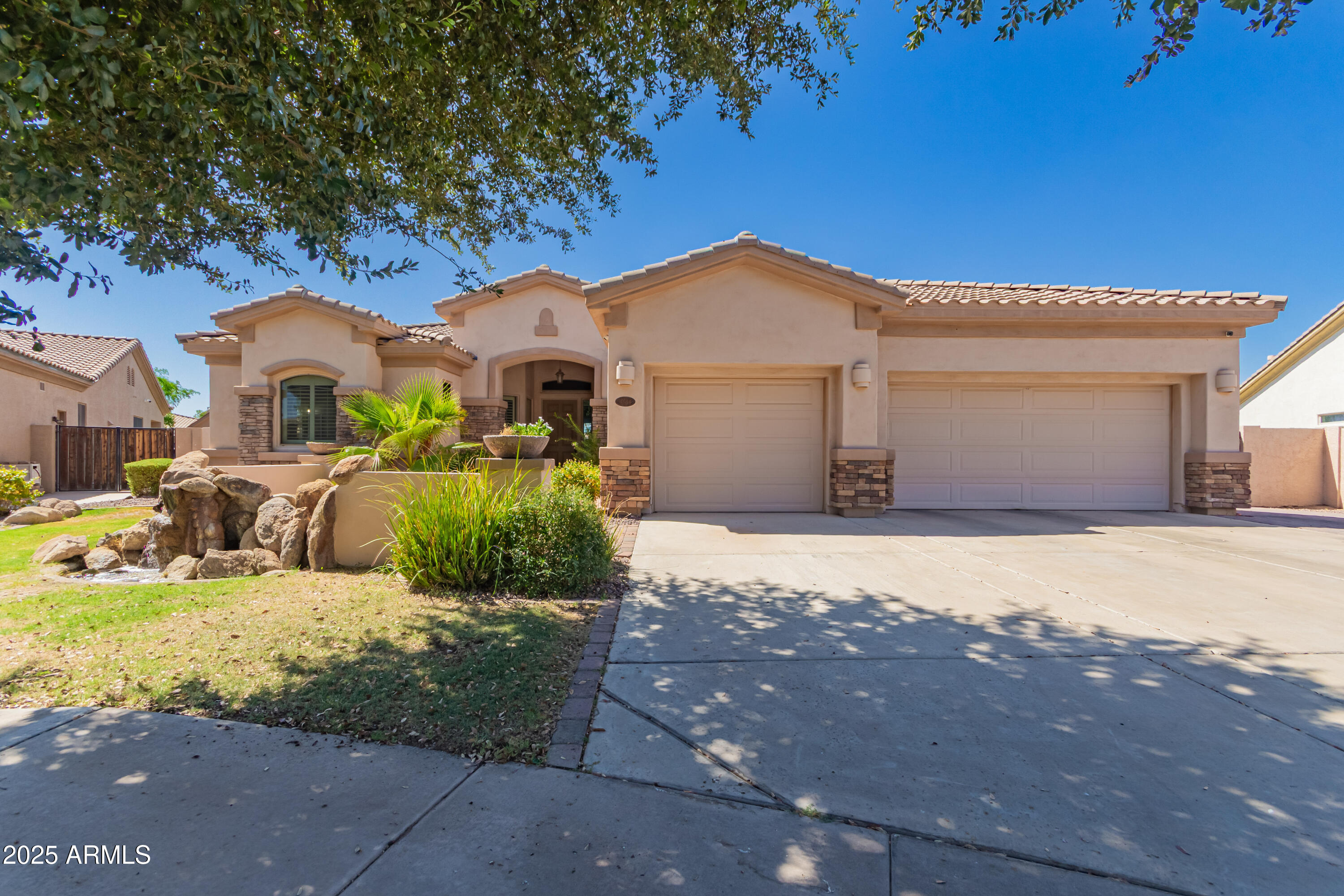 4584 East Reins Road Gilbert, AZ 85297 - Photo 1 of 58 a front view of a house with a yard