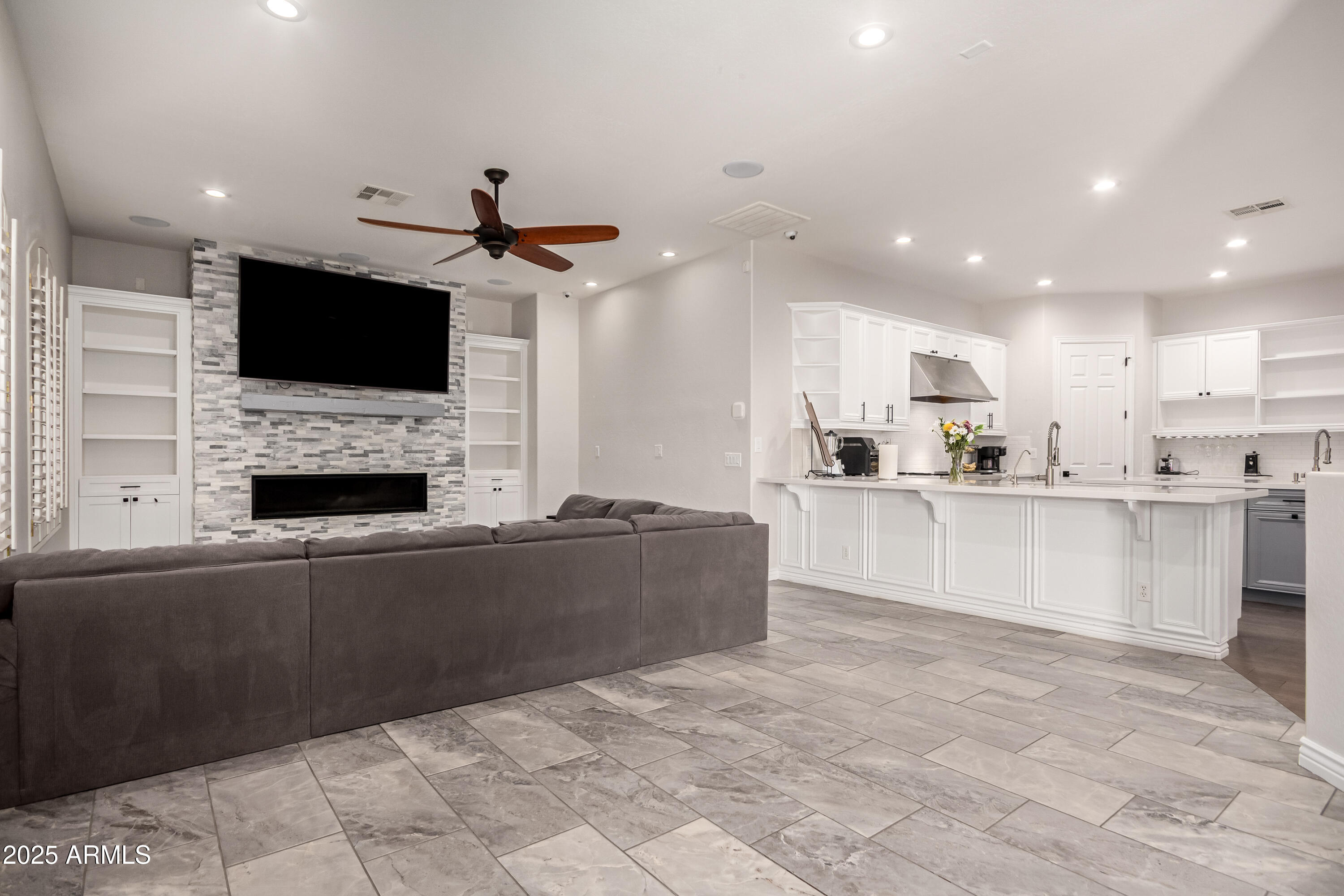 4584 East Reins Road Gilbert, AZ 85297 - Photo 11 of 58 a living room with fireplace and a flat screen tv