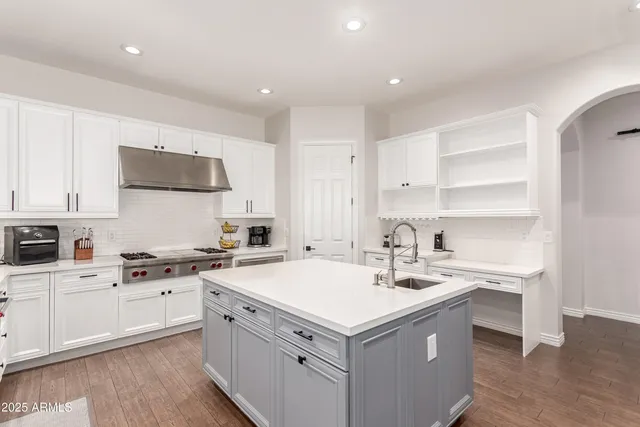 a kitchen with a stove and a sink
