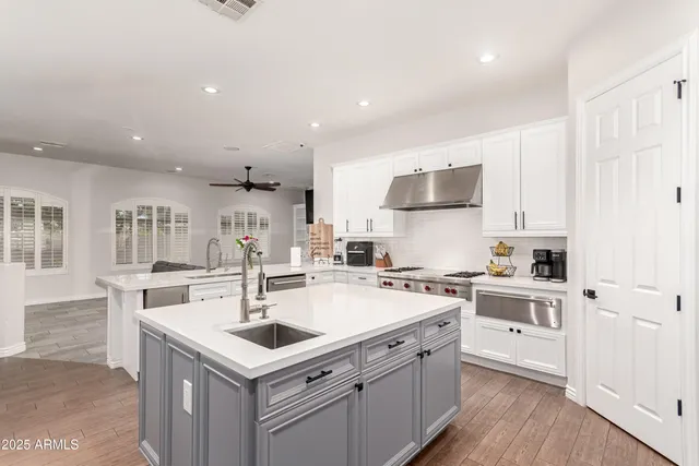 a kitchen with a stove a sink and a refrigerator