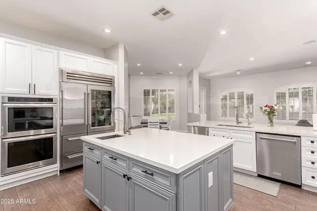 a bedroom with a bed a flat screen tv and a couch