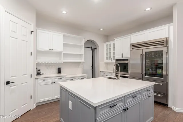 a bedroom with a bed a window and a flat screen television