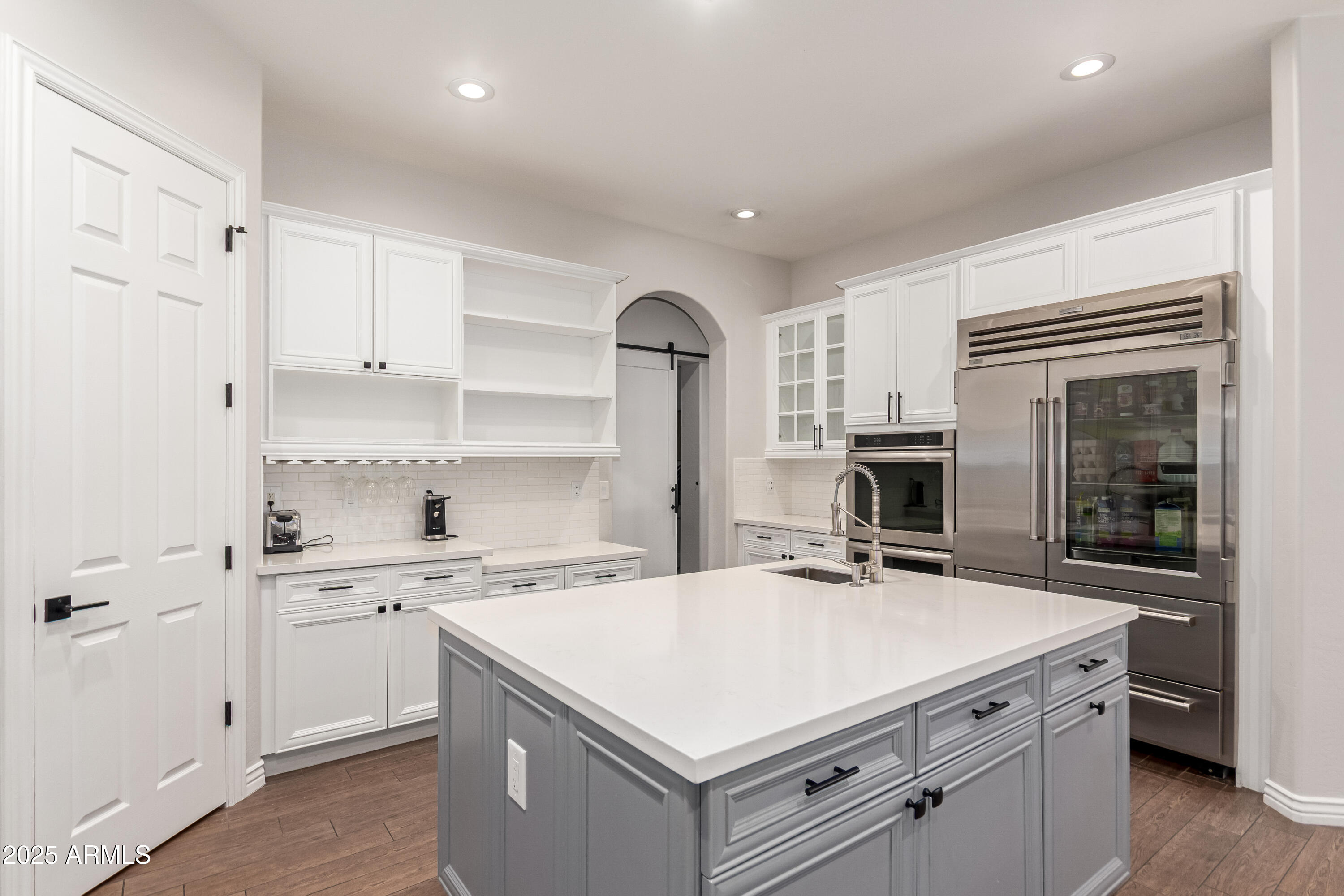 4584 East Reins Road Gilbert, AZ 85297 - Photo 16 of 58 a kitchen with a stove a sink and a refrigerator
