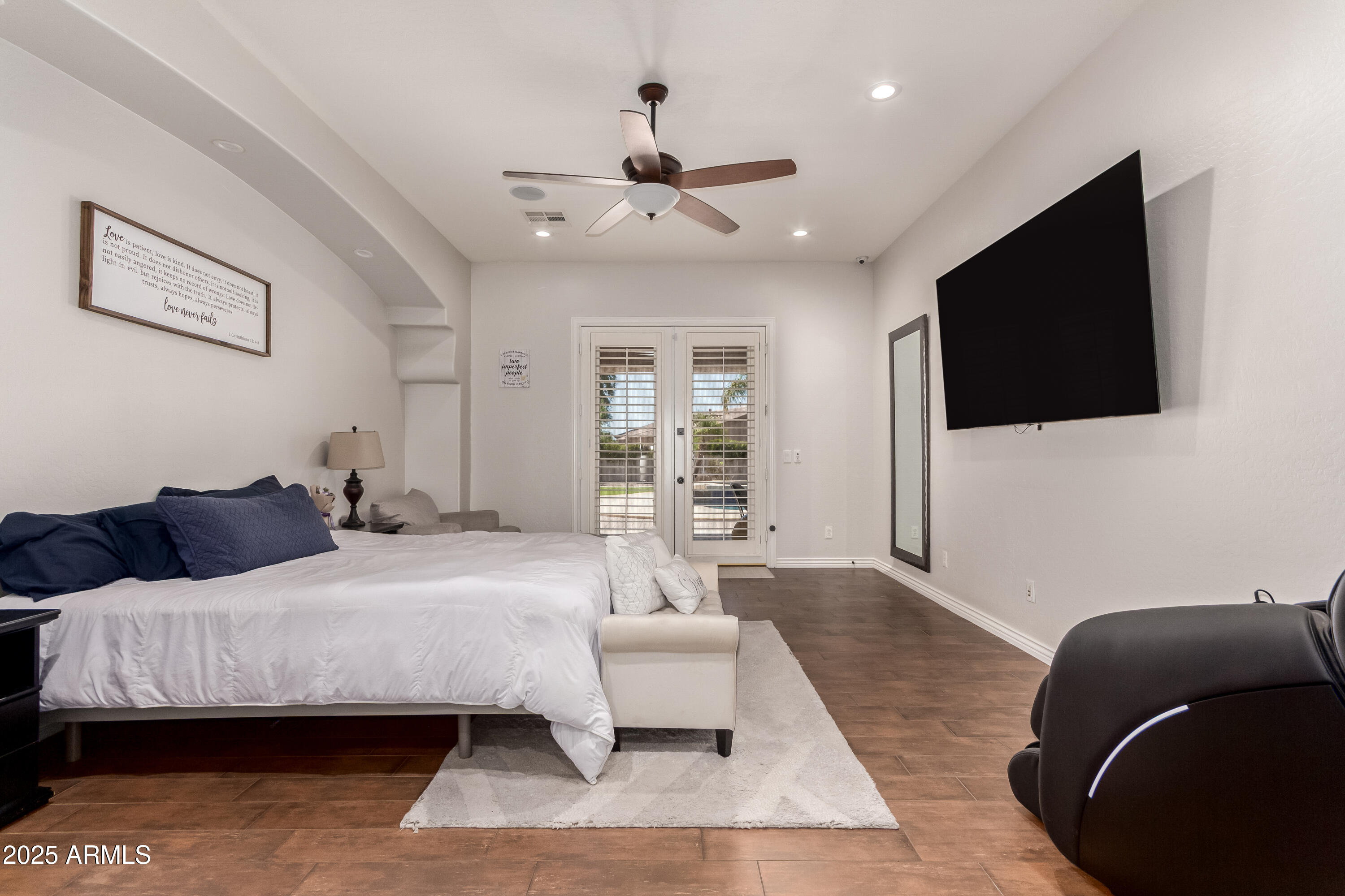 4584 East Reins Road Gilbert, AZ 85297 - Photo 17 of 58 a bedroom with a bed a flat screen tv and a couch