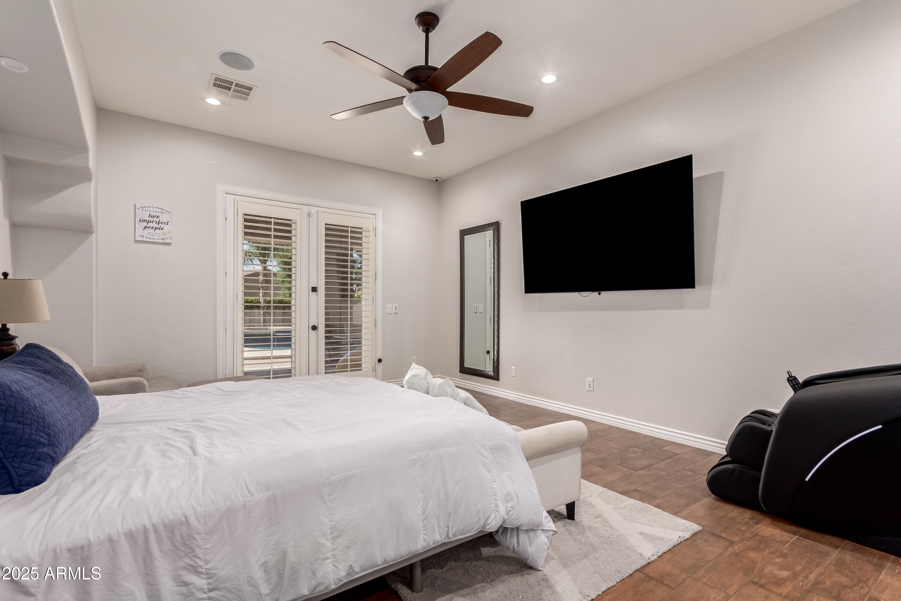 4584 East Reins Road Gilbert, AZ 85297 - Photo 18 of 58 a bedroom with a bed a window and a flat screen television