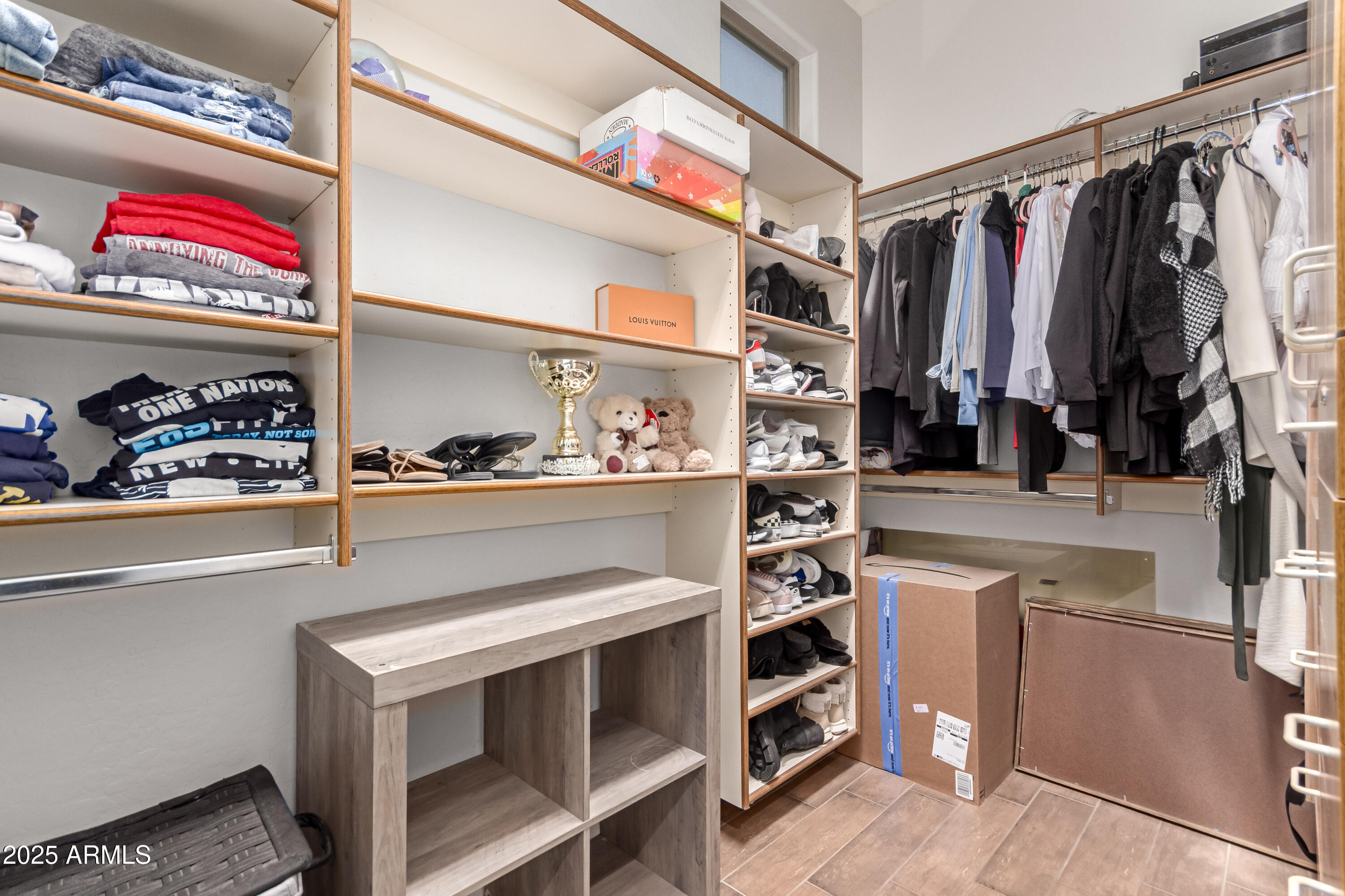 4584 East Reins Road Gilbert, AZ 85297 - Photo 22 of 58 a view of walk in closet with clothes and shoes