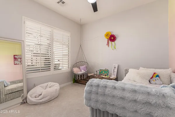 a living room with furniture and ceiling fan