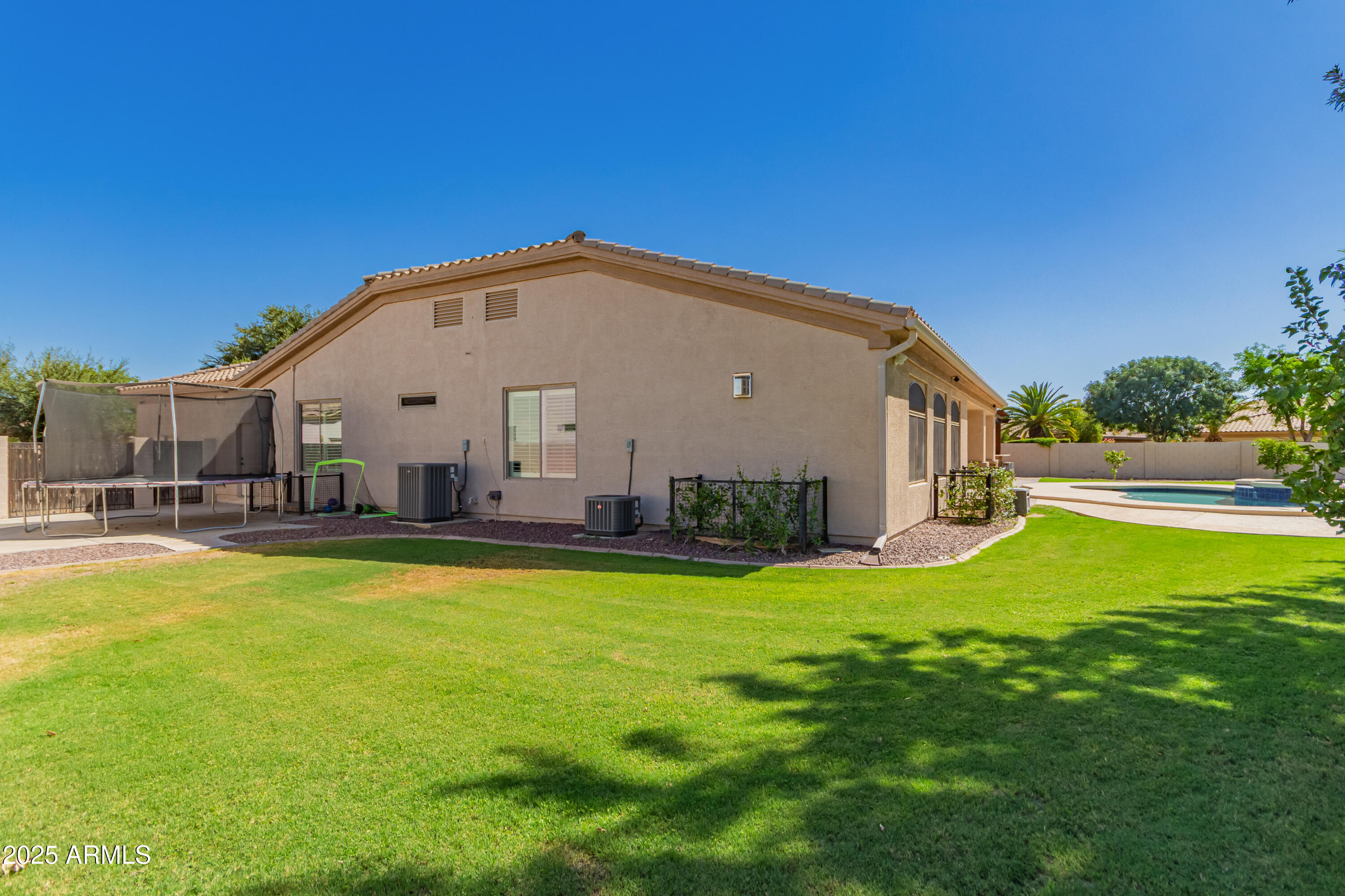 4584 East Reins Road Gilbert, AZ 85297 - Photo 51 of 58 a view of a house with pool and a yard