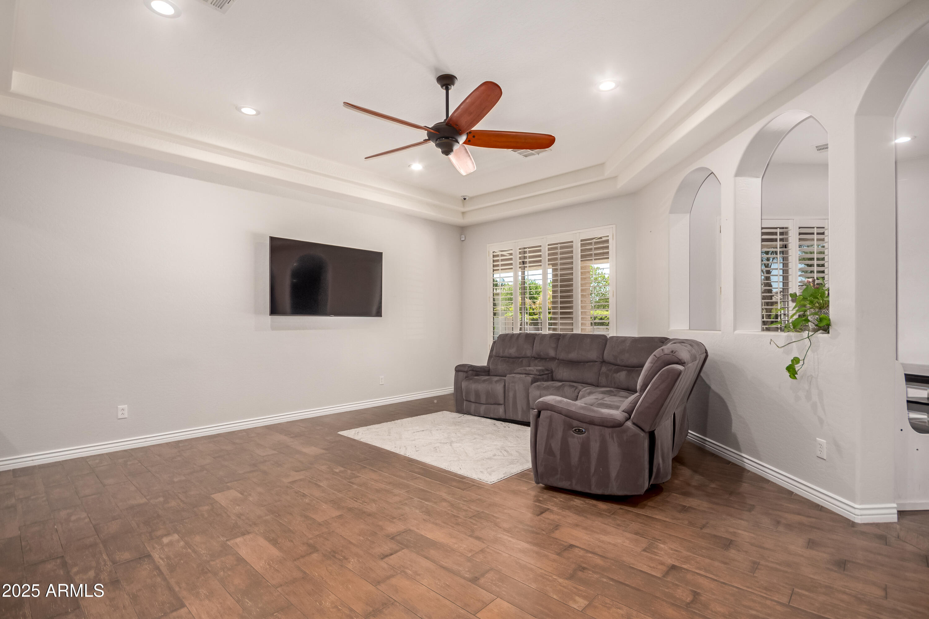 4584 East Reins Road Gilbert, AZ 85297 - Photo 7 of 58 a living room with furniture and a flat screen tv