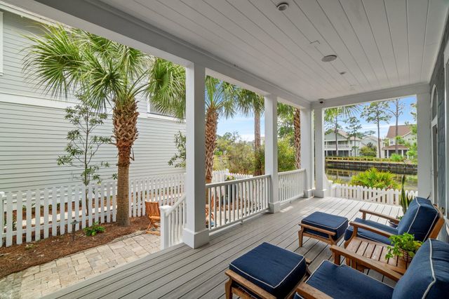 a view of a patio with a chair and potted plants