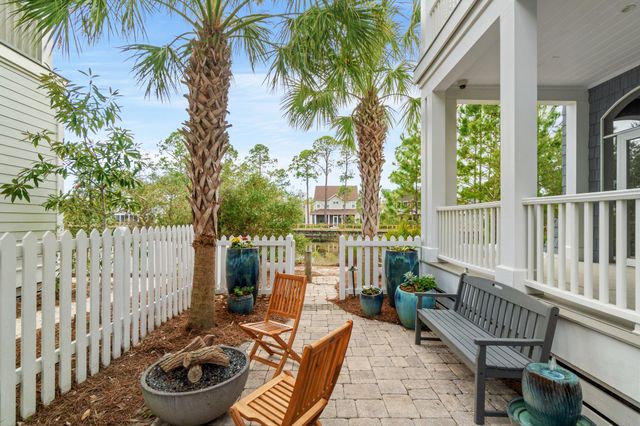 a view of a dining room with furniture large windows and wooden floor