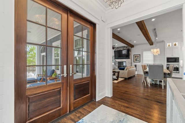 a living room with furniture a flat screen tv and next to a window