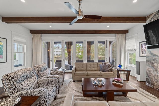 a living room with fireplace furniture and a floor to ceiling window