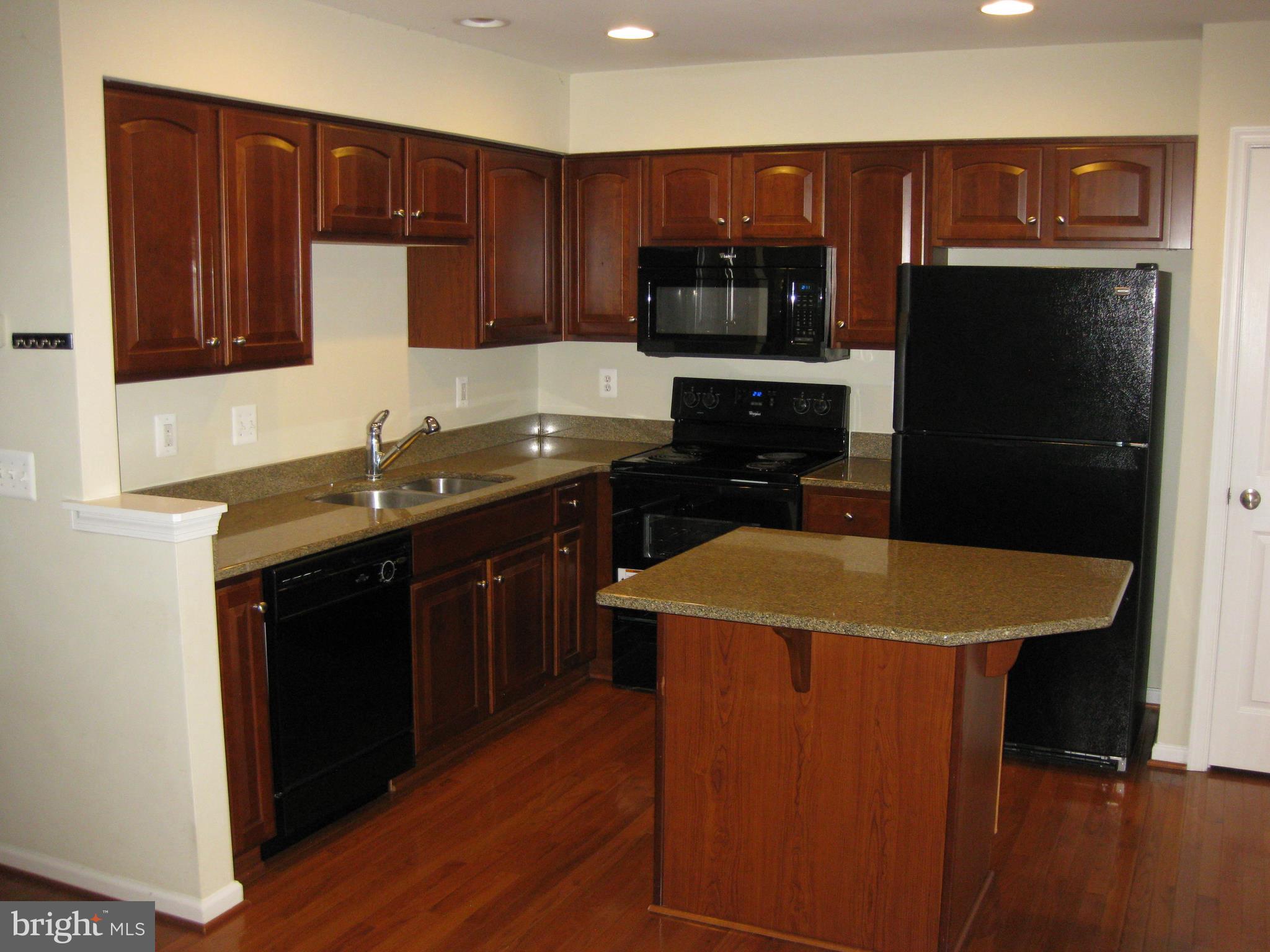 1252 Steed Street Ranson, WV 25438 - Photo 15 of 36 a kitchen with a sink and a refrigerator