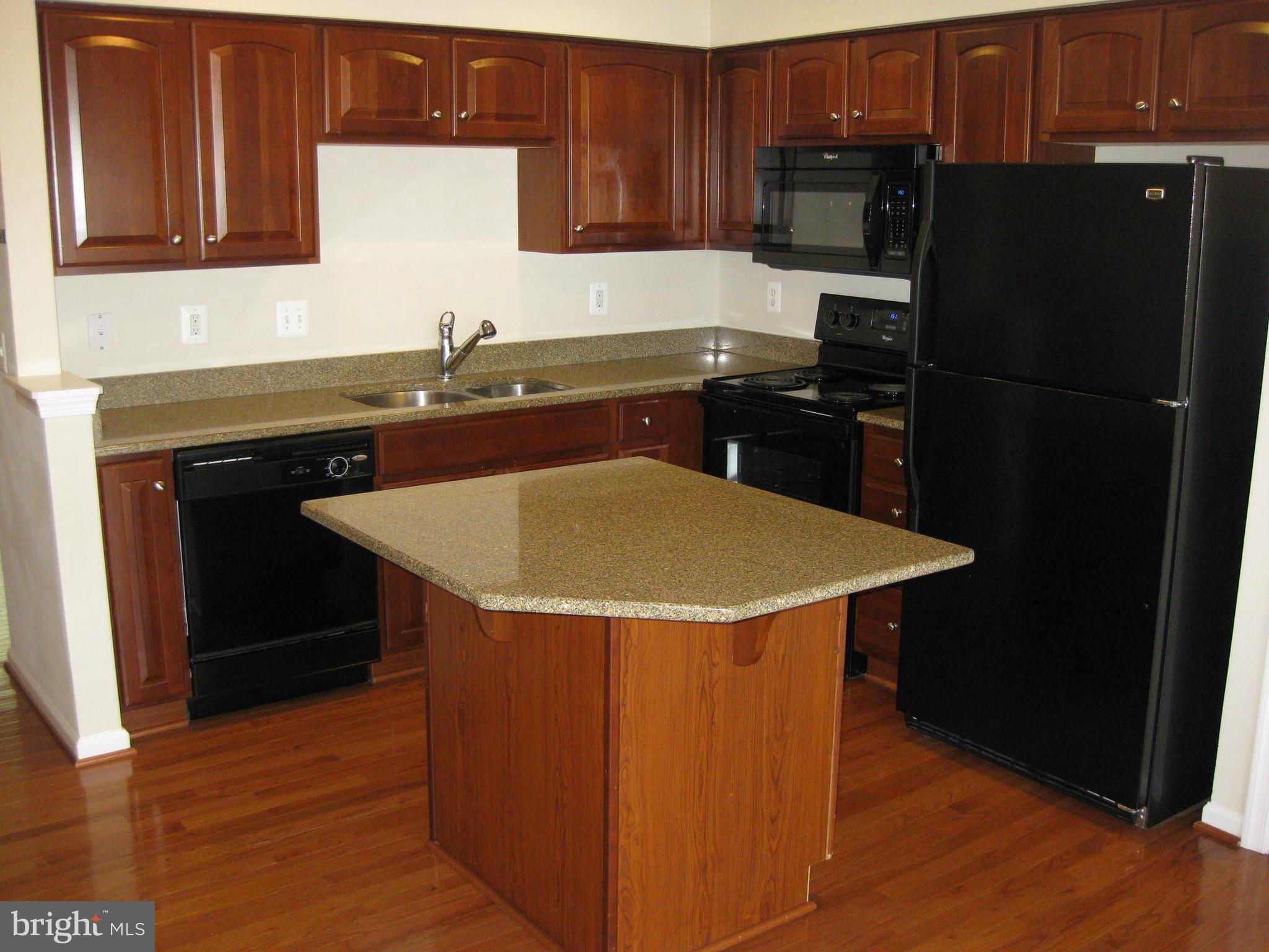 1252 Steed Street Ranson, WV 25438 - Photo 16 of 36 a kitchen with a sink a refrigerator and cabinets
