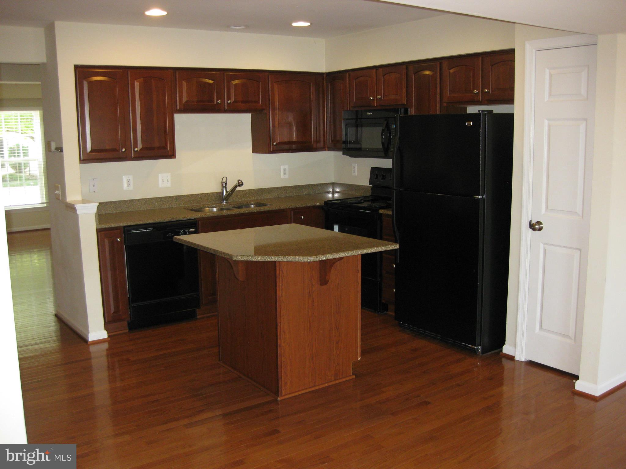 1252 Steed Street Ranson, WV 25438 - Photo 17 of 36 a kitchen with a sink and a refrigerator