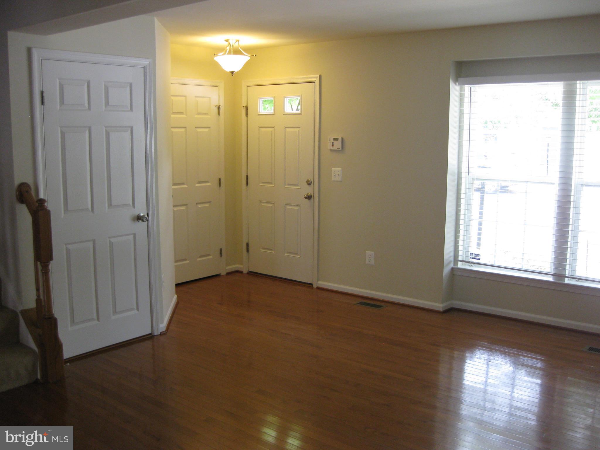 1252 Steed Street Ranson, WV 25438 - Photo 8 of 36 an empty room with wooden floor and a window