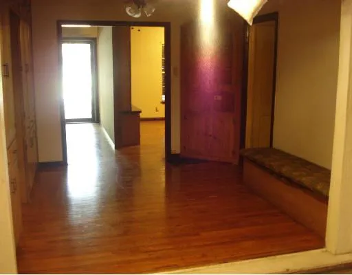 a view of a room with wooden floor and windows