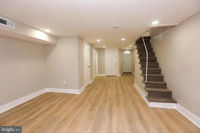 a view of a room with wooden floor and stairs
