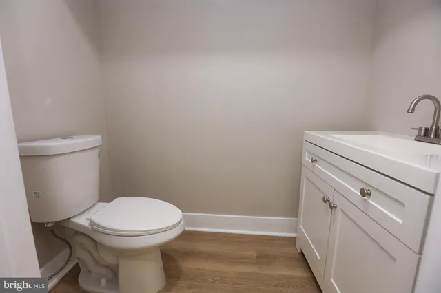 a bathroom with a toilet a sink and vanity