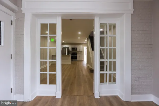 an entryway with wooden floor and windows