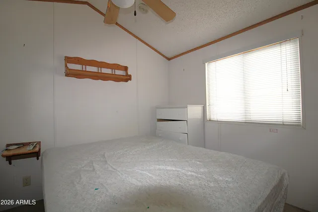 a room with chandelier fan and windows