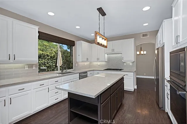 a kitchen with a stove sink and refrigerator