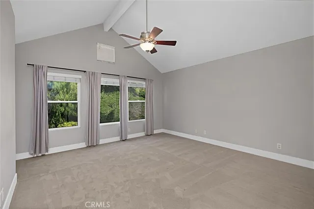 an empty room with closet and a chandelier fan