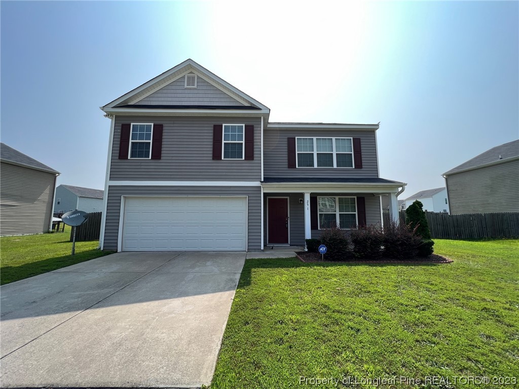 251 Botanical Court Bunnlevel, NC 28323 - Photo 1 of 20 a front view of a house with a yard and garage