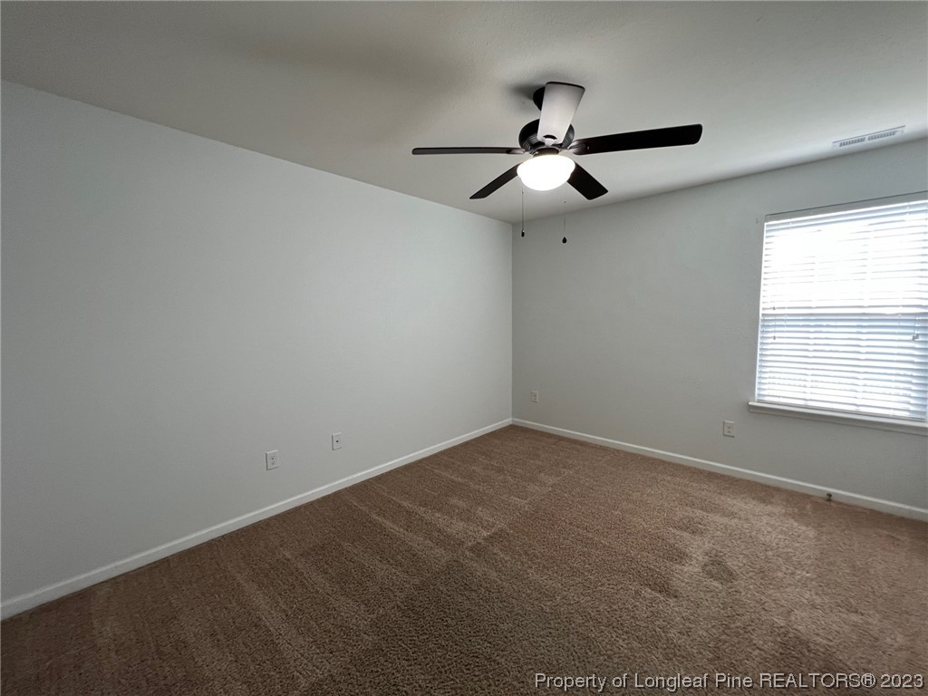 251 Botanical Court Bunnlevel, NC 28323 - Photo 14 of 20 an empty room with a window and a fan