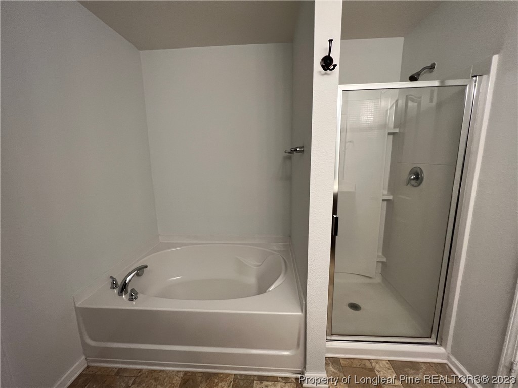 251 Botanical Court Bunnlevel, NC 28323 - Photo 17 of 20 a bathroom with a tub and shower
