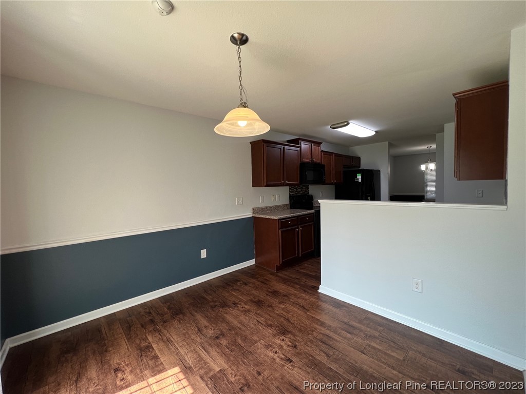 251 Botanical Court Bunnlevel, NC 28323 - Photo 7 of 20 a kitchen with stainless steel appliances granite countertop a sink a stove and a wooden floors
