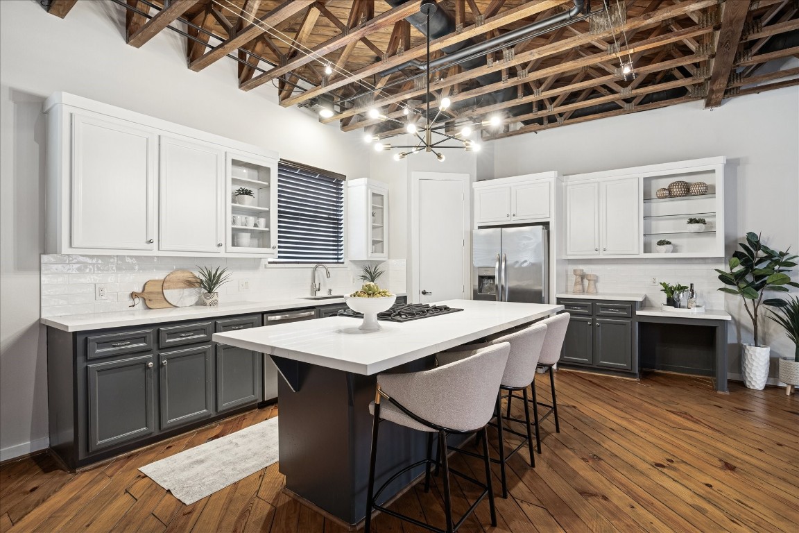 910 Malone Street, Unit 104 Houston, TX 77007 - Photo 13 of 44 Recently renovated kitchen boasts quartz countertops and subway tile backsplash, painted in a modern color palette