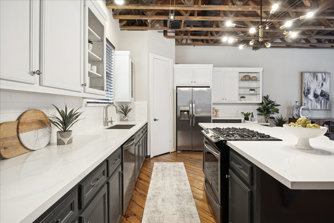 910 Malone Street, Unit 104 Houston, TX 77007 - Photo 14 of 44 Kitchen equipped with ample counter space, cabinets and drawers... and large pantry next to refrigerator