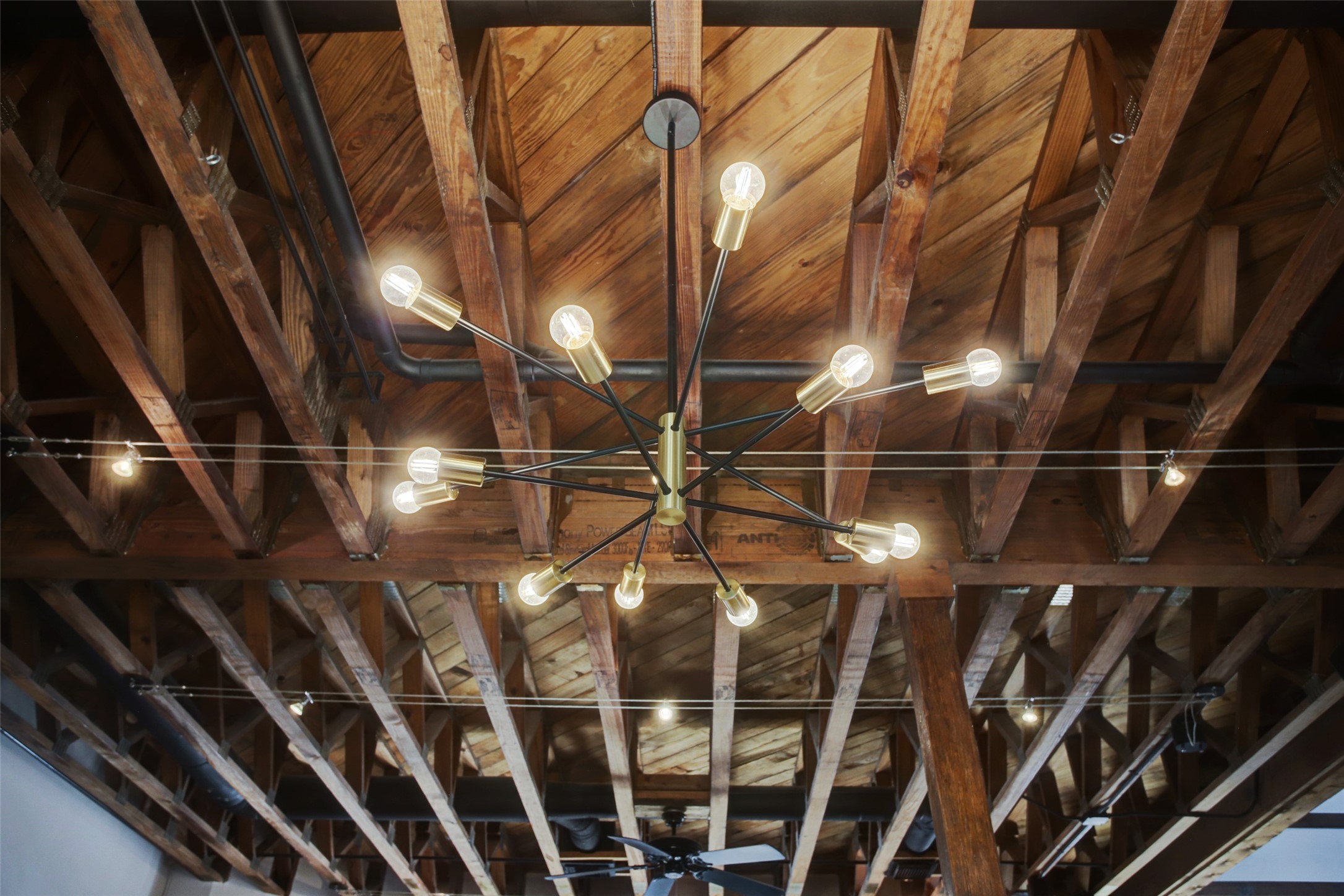 910 Malone Street, Unit 104 Houston, TX 77007 - Photo 17 of 44 Elevate your kitchen experience with a striking Sputnik chandelier set against an open trussed ceiling