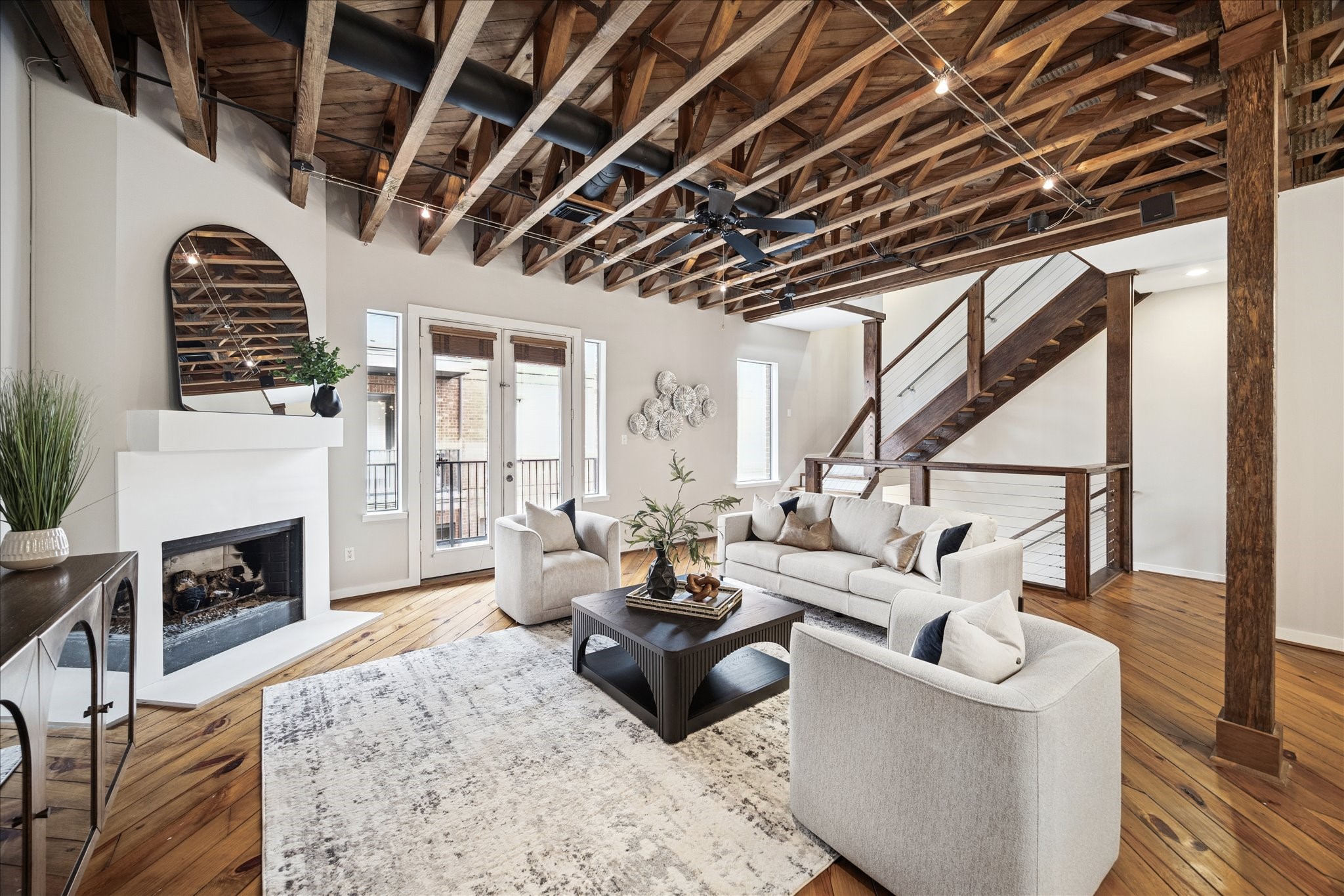 910 Malone Street, Unit 104 Houston, TX 77007 - Photo 22 of 44 Cozy living area with a gas log fireplace, elegant mantel, and private balcony