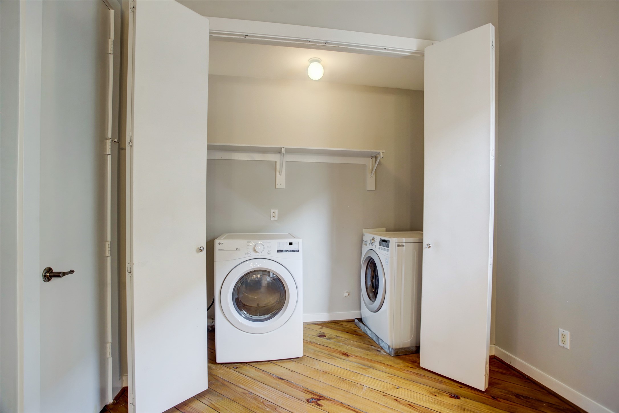 910 Malone Street, Unit 104 Houston, TX 77007 - Photo 26 of 44 Close up of utility closet with full size washer and dryer, complete with shelf