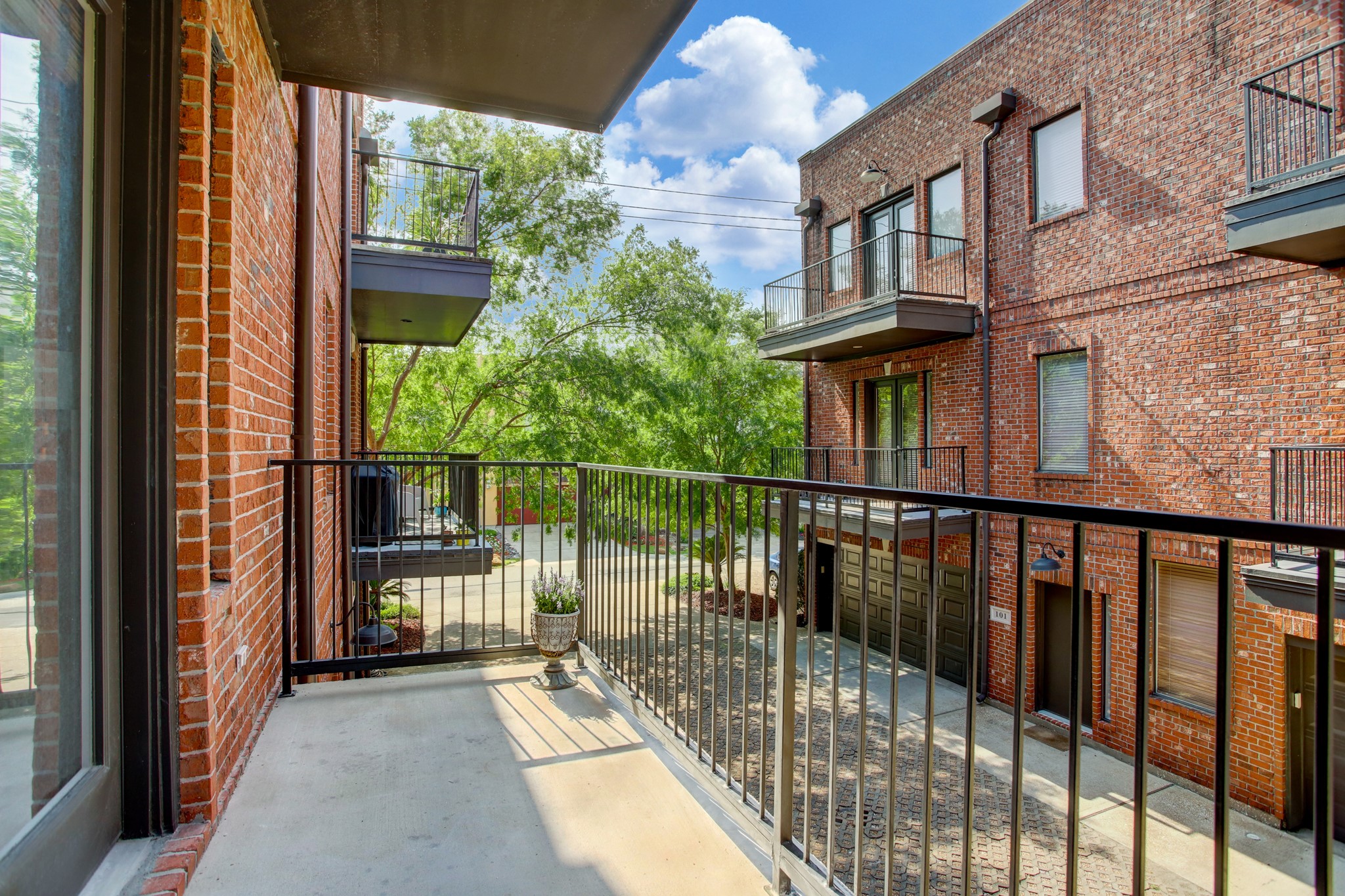 910 Malone Street, Unit 104 Houston, TX 77007 - Photo 3 of 44 Covered balcony conveniently located off the living area... spacious enough for a grill, and bistro table