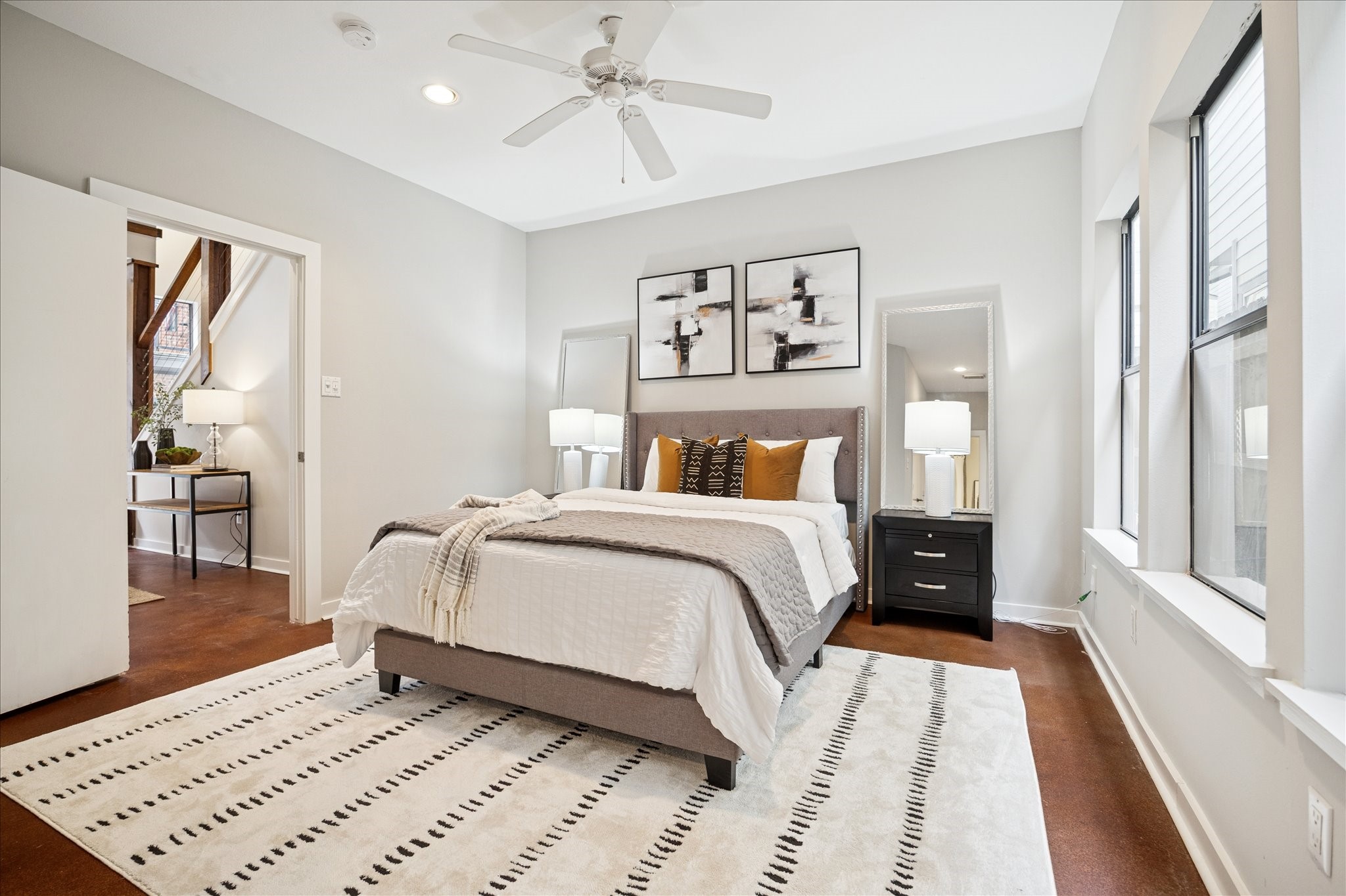 910 Malone Street, Unit 104 Houston, TX 77007 - Photo 9 of 44 Light, bright and freshly painted first floor Secondary bedroom, with stained concrete floors and ensuite bath