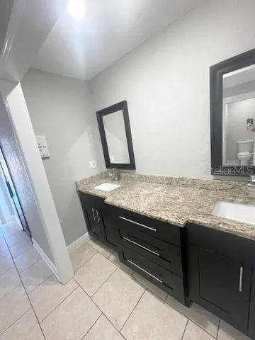 a view of kitchen with granite countertop stove sink and dishwasher
