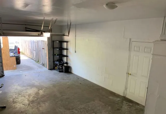 a view of a room with wooden floor and window