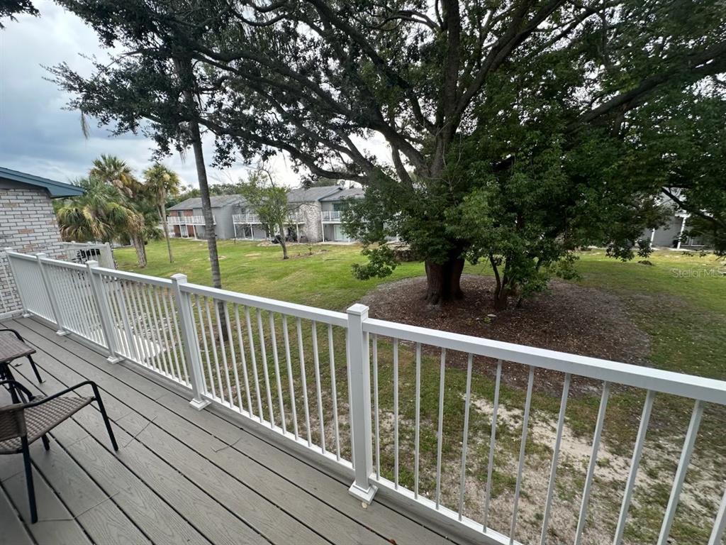 7429 Daniel Webster Drive, Unit 14 (#C) Winter Park, FL 32792 - Photo 14 of 15 a view of a wooden deck and trees with wooden fence