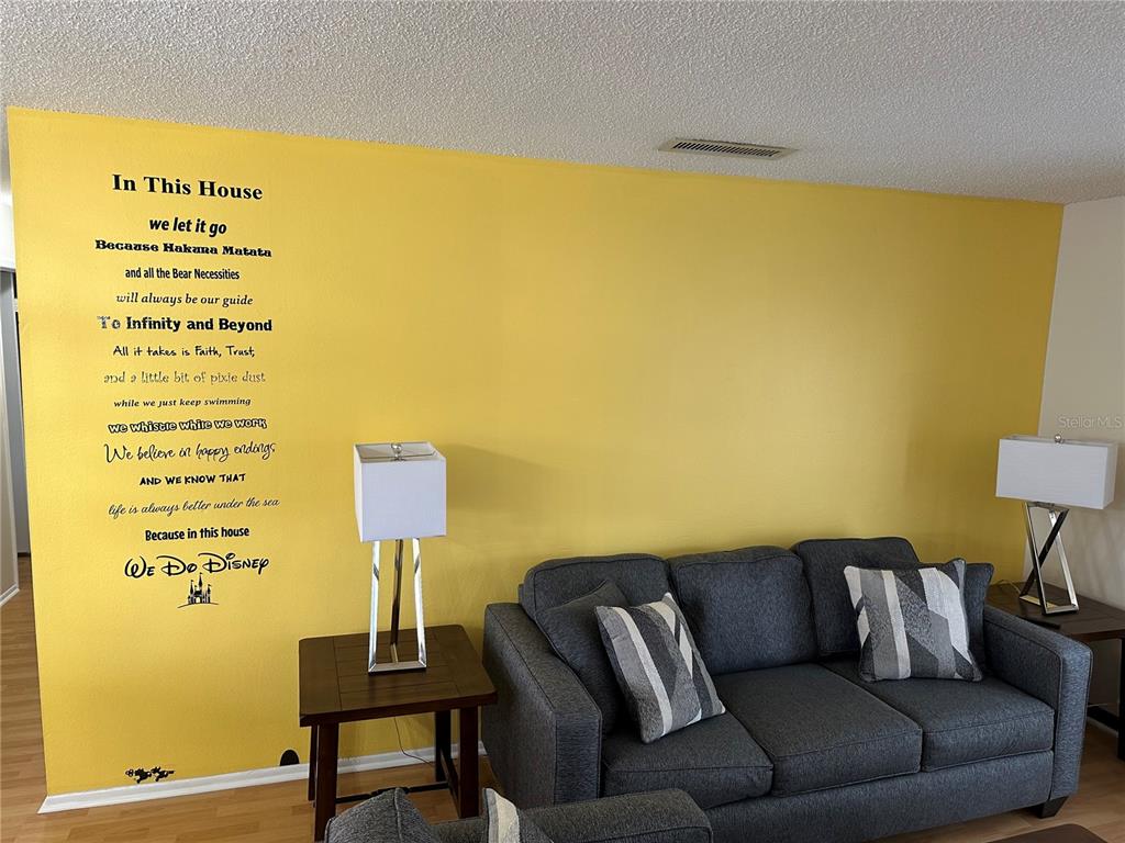 7429 Daniel Webster Drive, Unit 14 (#C) Winter Park, FL 32792 - Photo 4 of 15 a living room with a couch and a table