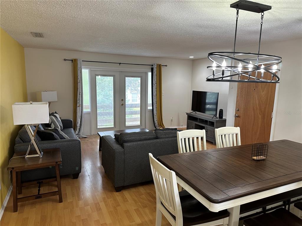 7429 Daniel Webster Drive, Unit 14 (#C) Winter Park, FL 32792 - Photo 8 of 15 a living room with furniture and a flat screen tv