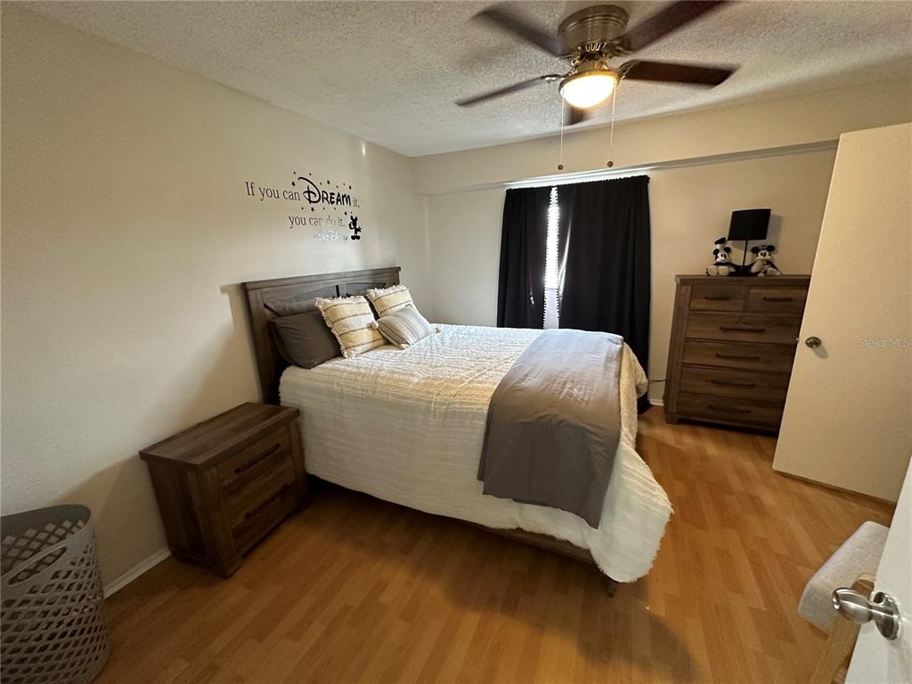 7429 Daniel Webster Drive, Unit 14 (#C) Winter Park, FL 32792 - Photo 9 of 15 a bedroom with bed and wooden floor