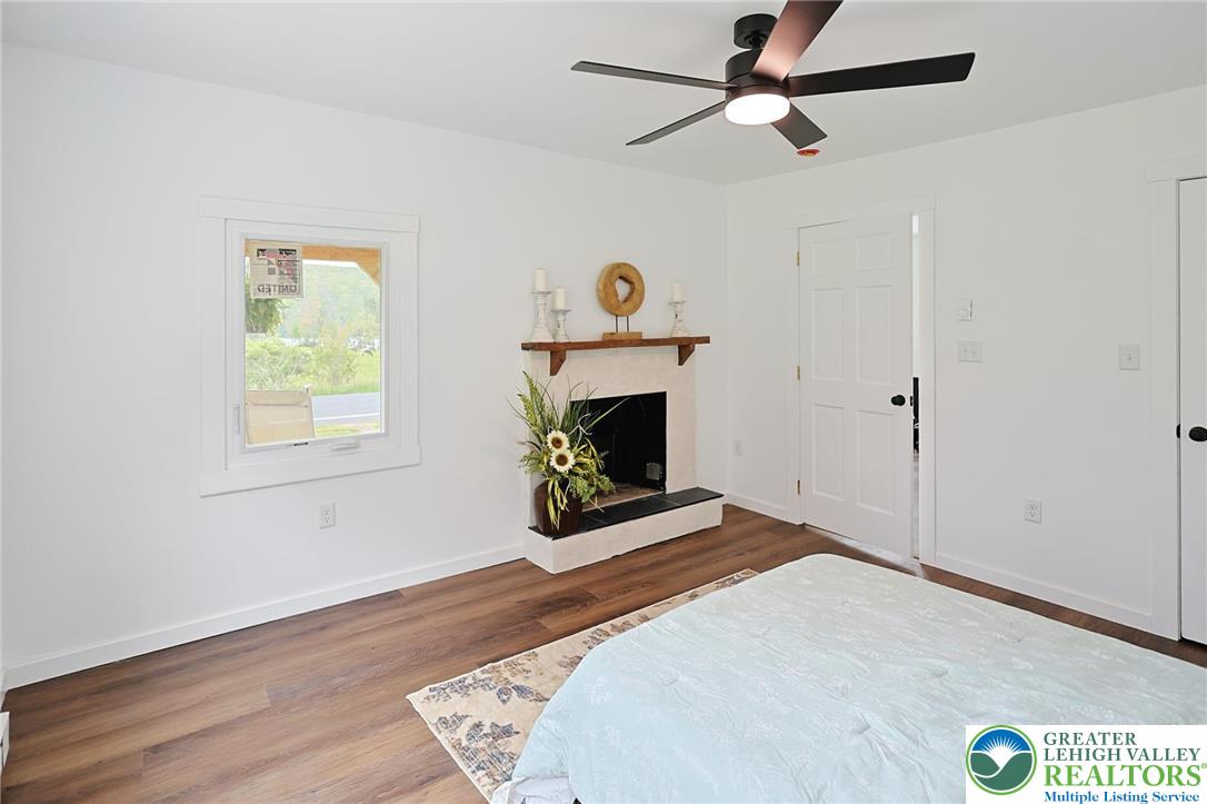 121 Ben Titus Road Tamaqua, PA 18252 - Photo 26 of 48 a bedroom with a bed and a fireplace