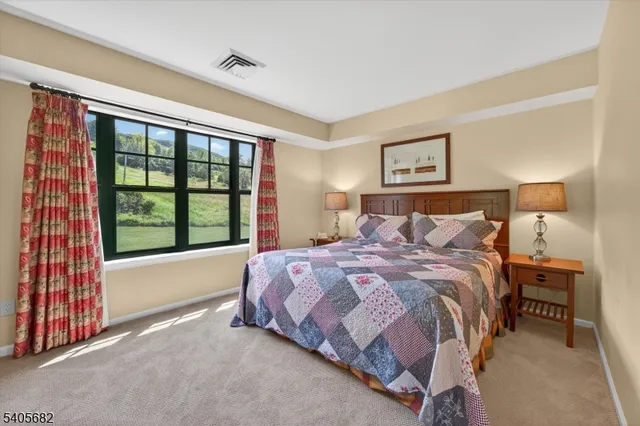 a spacious bedroom with a bed and a cabinets